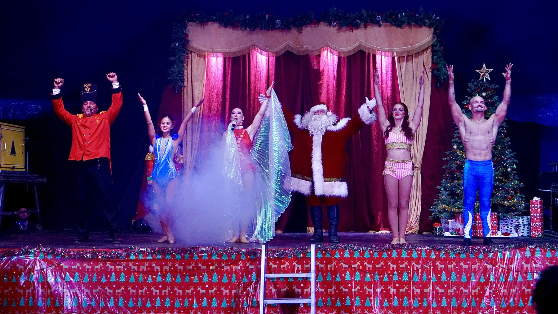 Holiday circus cast taking a bow under the Big Top